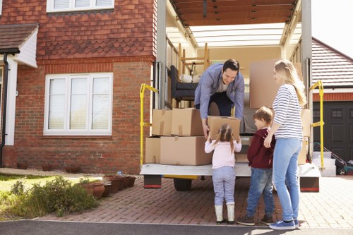 Local movers preparing fragile items for transport in Camden