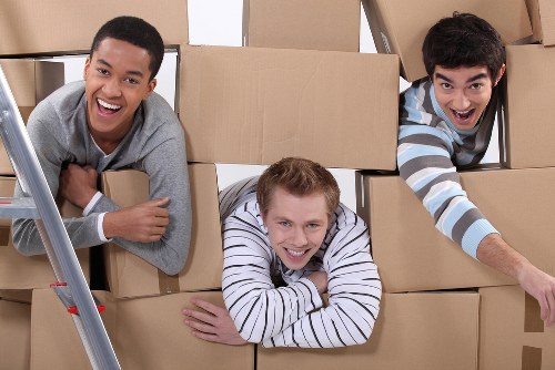 Professional team loading a sofa and chair during Camden furniture pick-up