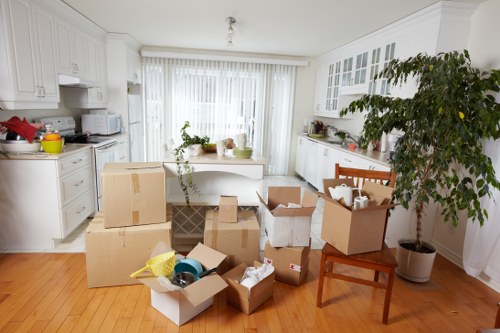 Removal team unloading furniture into a Camden family home