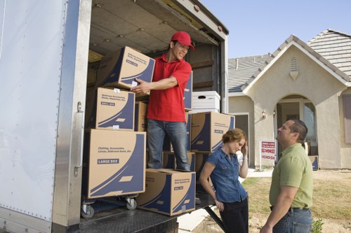 Helper carrying boxes during a Camden move